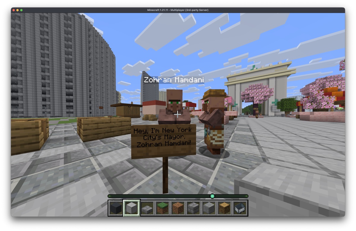 Mayor Zohran Mamdani villager with a sign